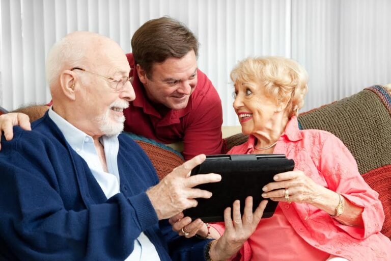Senior couple get a gift of a tablet PC from their adult son